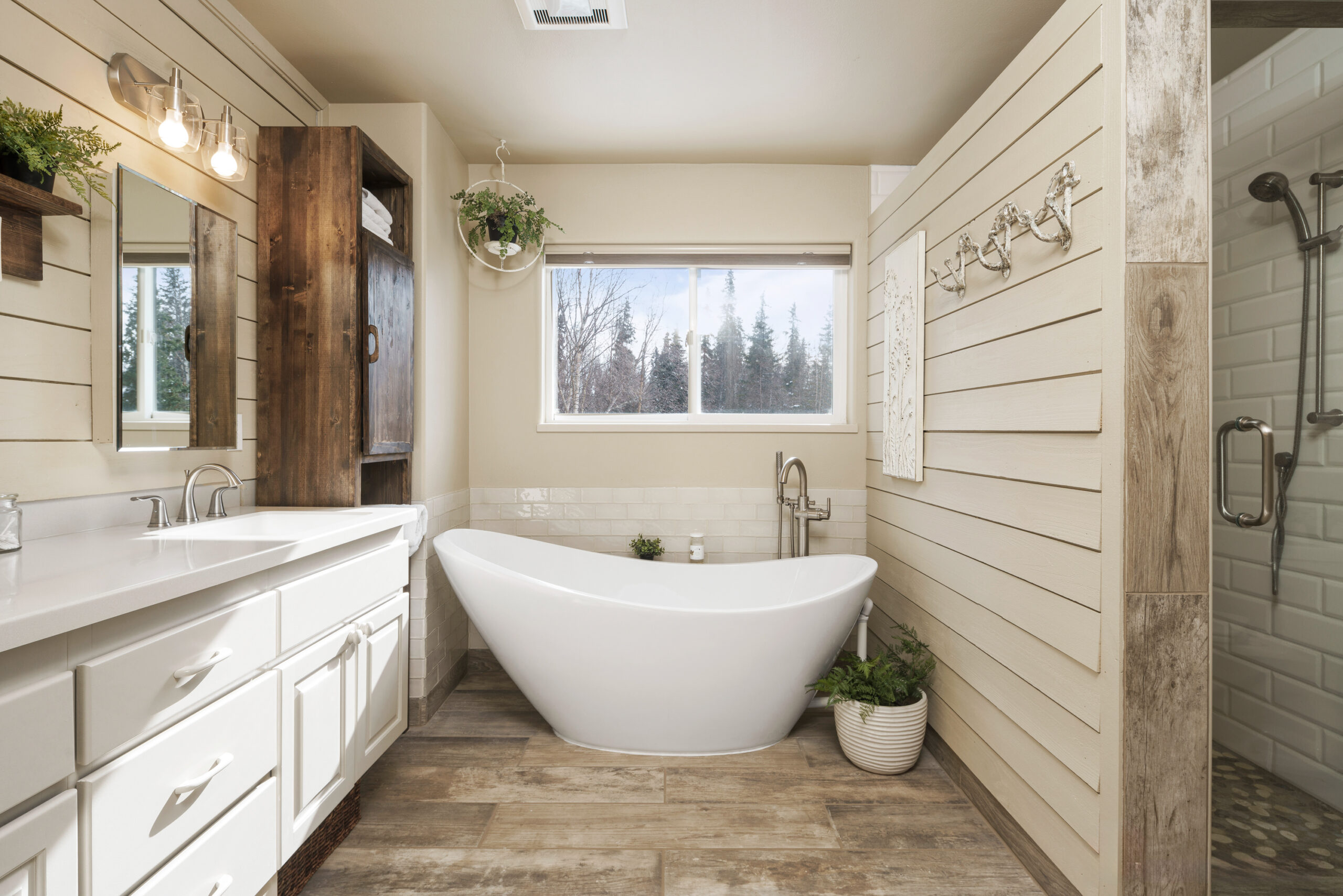 The photograph showcases a bathroom that is the epitome of serene luxury, ideal for homeowners who appreciate modern design paired with comfort. The photographer, Marcus Biastock, has demonstrated technical competence through:

Composition: The photo composition is well-balanced, capturing the spaciousness of the room and the natural light from the large window.
Lighting: Skillful use of natural light accentuates the clean lines and high-quality finishes of the bathroom.
Focus: Sharp focus on the freestanding bathtub and wooden cabinet emphasizes the room’s elegant fixtures.
Color Balance: The warm tones of the wooden cabinet against the cool white of the bathtub create a visually appealing contrast.
This bathroom, with its contemporary design and functional elegance, is a highlight for any property listing in Seattle, WA. Marcus Biastock’s photography brings out the best in this space, making it a compelling feature for potential buyers