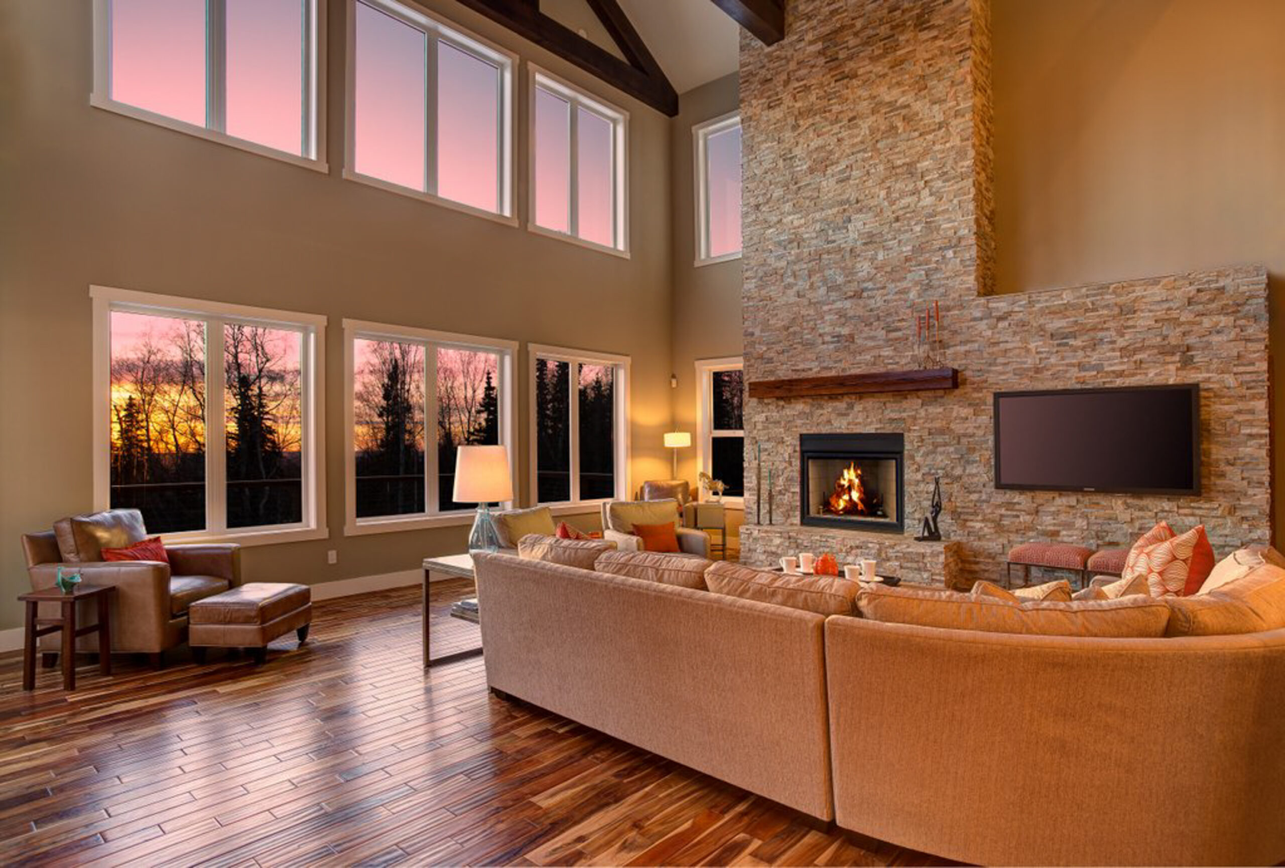 Step into the warmth of this elegantly designed living room, where sunset hues and a cozy fireplace invite relaxation. Perfect for those seeking a luxurious yet comfortable space, this room exemplifies modern living with a touch of tranquility.