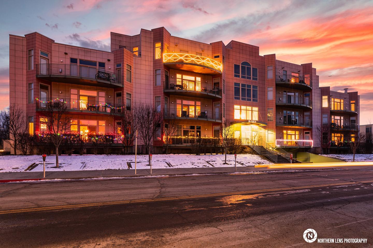 Condo building exterior photo taken at sunset.