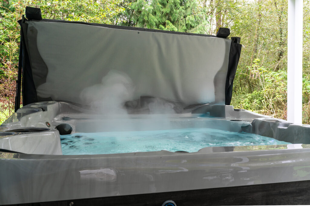 Discover the ultimate relaxation experience with our outdoor hot tub surrounded by natural greenery. Enjoy the warm, steaming waters in your private oasis.