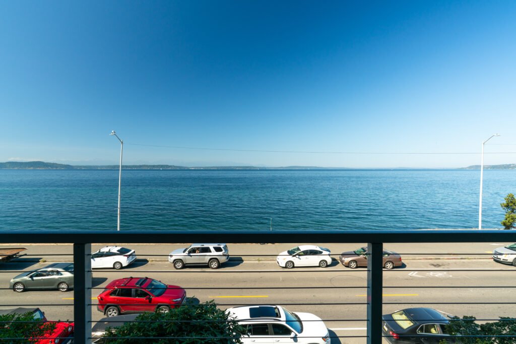 Panoramic balcony view of Puget Sound and distant islands from Alki Beach waterfront condo.