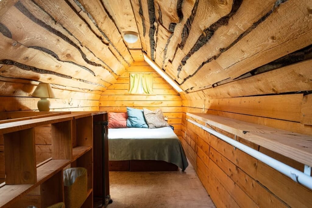 Pacific Northwest Airbnb master bedroom with expansive windows and bright natural lighting photographed for vacation rental listing